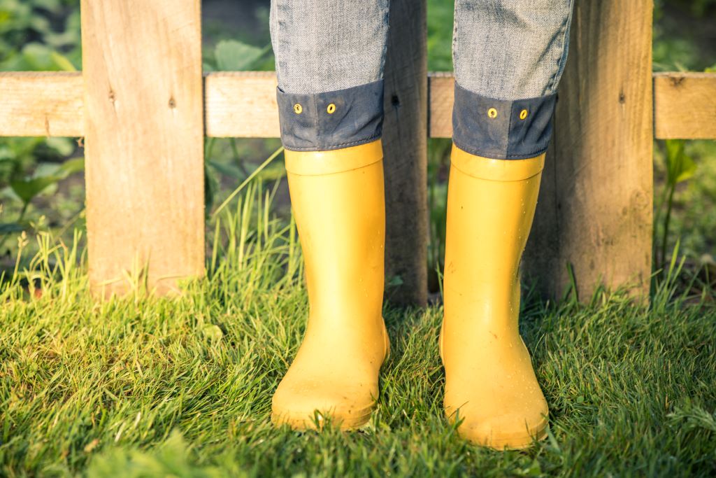 Person wearing smart yellow wellie boots at a natural burial